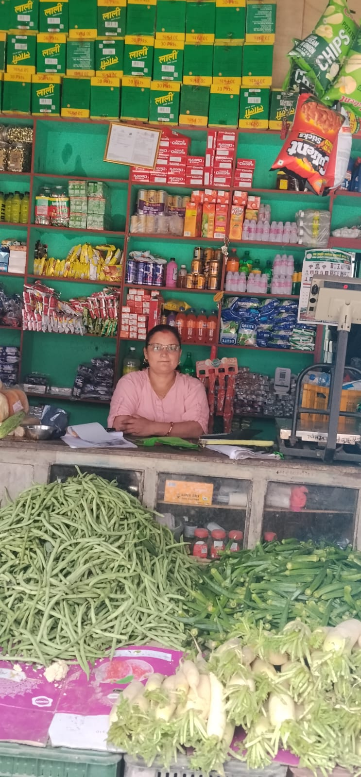 Owner at the counter — rice, oil and daily groceries at our Darbang Myagdi kirana shop